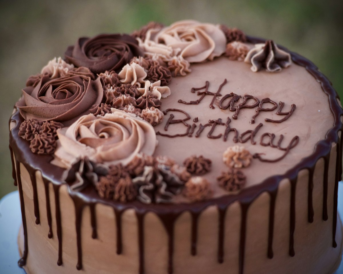 Chocolate birthday cake decorated with piped roses
