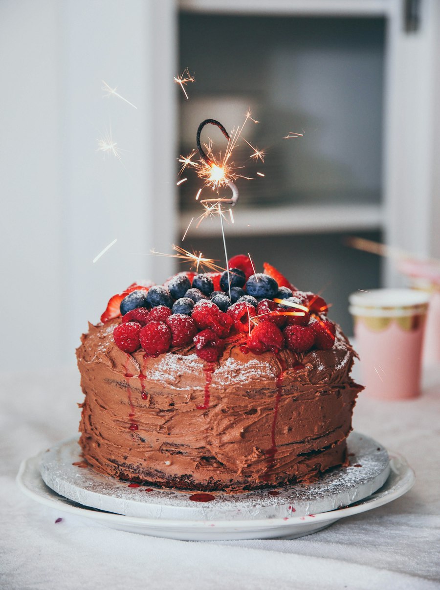 Chocolate celebration cake with berries and a sparkler