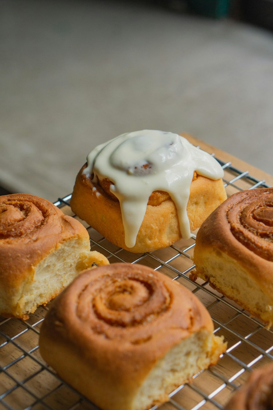 Iced cinnamon rolls on a cooling rack