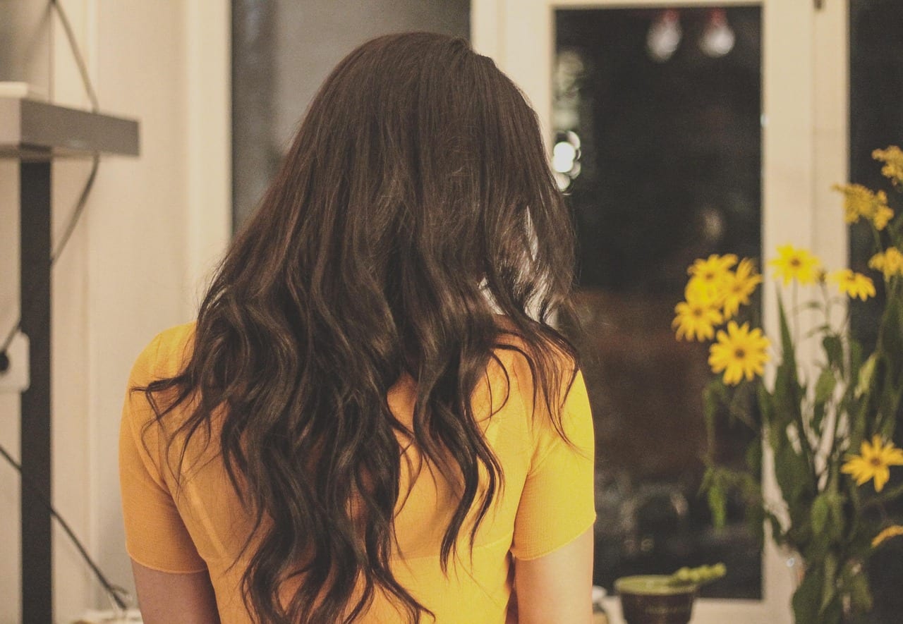 Long brunette waves seen from behind