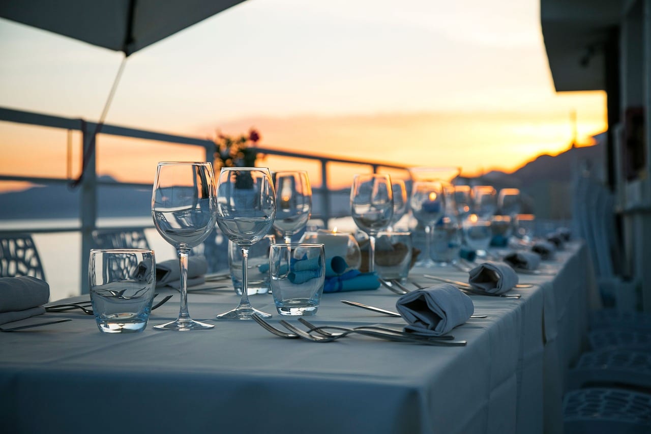 Long table set on the harbor terrace at sunset