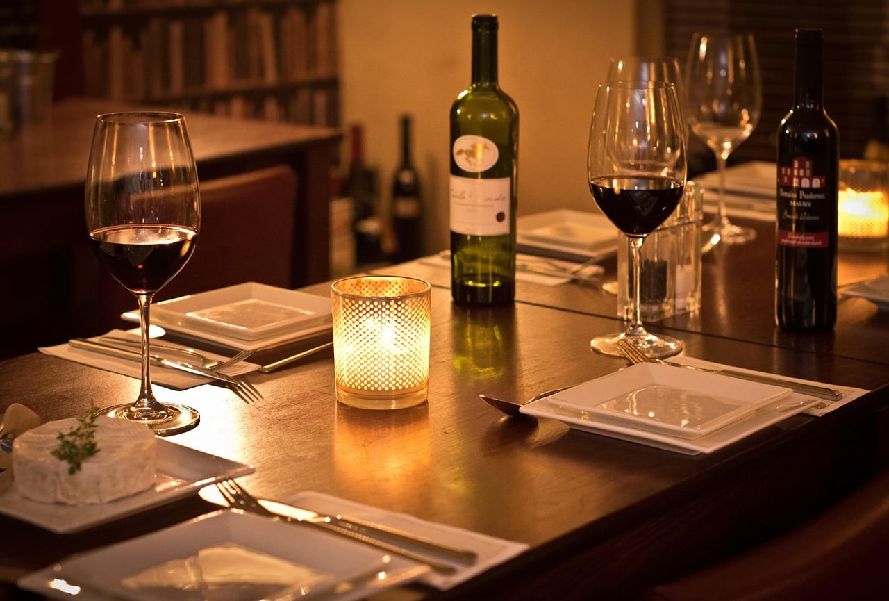 Candlelit table set with wine glasses